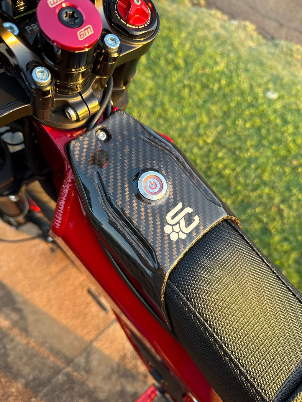 Close-up of a talaria xxx with a real carbon fiber part ignition cover ignition plate